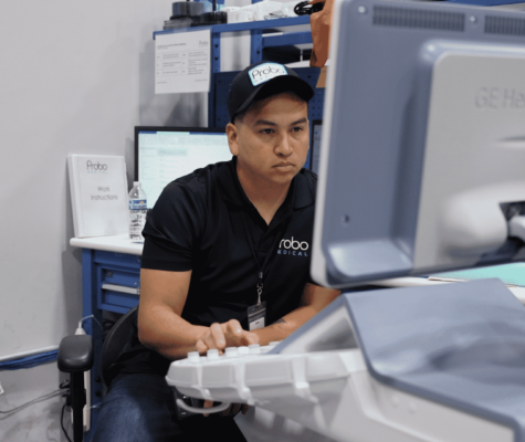 Ultrasound quality assurance technician testing refurbished ultrasound machine